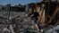 A man walks on the site of a municipal market destroyed by a Russian military strike in the border town of Vovchansk on Junje 4.