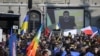 Ukrainian President Volodymyr Zelensky speaks on a giant screen during a demonstration against the Russian invasion of Ukraine in front of the Swiss parliament in Bern on March 19. 