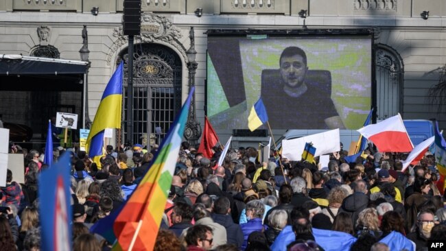 Ukrainian President Volodymyr Zelensky speaks on a giant screen during a demonstration against the Russian invasion of Ukraine in front of the Swiss parliament in Bern on March 19. 