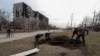 People dig graves where they can for victims of the Russian bombardment in Mariupol on March 20.