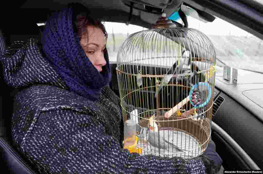 A woman and her pet cockatiel pass through a Russian military checkpoint as they attempt to flee Mariupol on April 17.