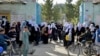 Girls leave their school following an order to close just hours after reopening in Kabul on March 23.