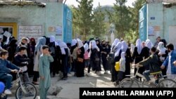 Girls leave their school following an order to close just hours after reopening in Kabul on March 23.