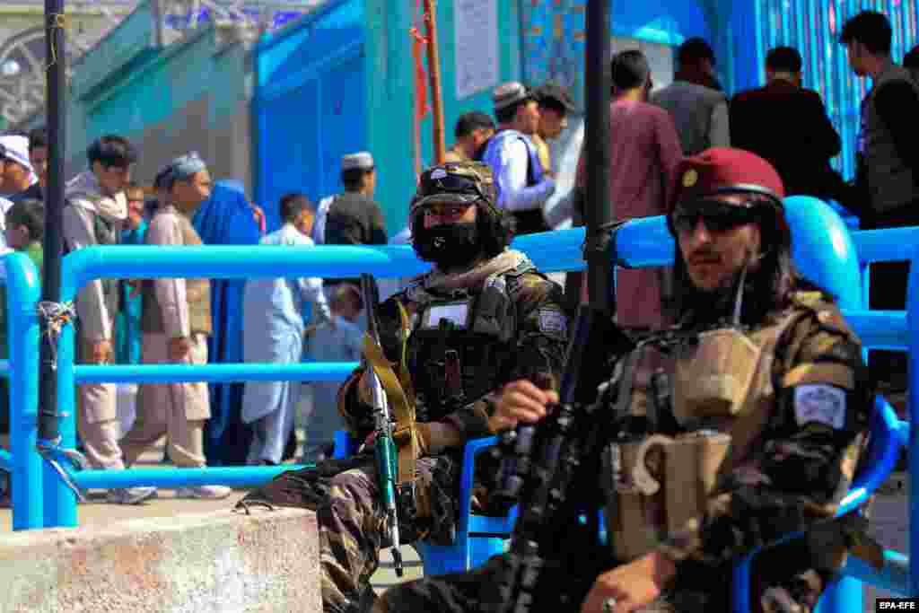 &nbsp;Taliban soldiers keep watch as Afghans celebrate Norouz in Kabul.