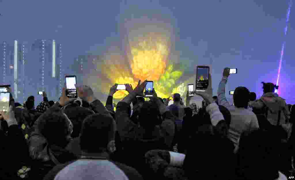 People film the festivities in Tehran.