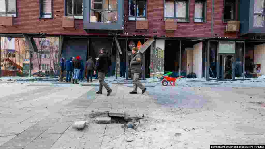 Shattered windows above a damaged pavement after a rocket attack on the&nbsp;Shevchenko district of Kyiv on March 23.&nbsp;