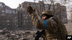 A Ukrainian soldier takes up a position in Mariupol.