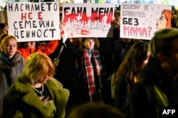 Protesters hold banners during a demonstration against domestic violence on the International Day for the Elimination of Violence Against Women, in Sofia on November 25, 2021.