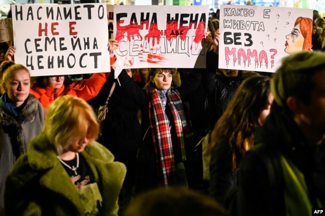 Protesters hold banners during a demonstration against domestic violence on the International Day for the Elimination of Violence Against Women, in Sofia on November 25, 2021.