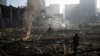 Ukraine -- People gather among the remains of an attack on a shopping mall in kyiv, Ukraine, Monday, March 21, 2022. (AP Photo/ (AP Photo/Rodrigo Abd))