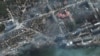 Residential buildings burn in the encircled, besieged city of Mariupol on March 21.