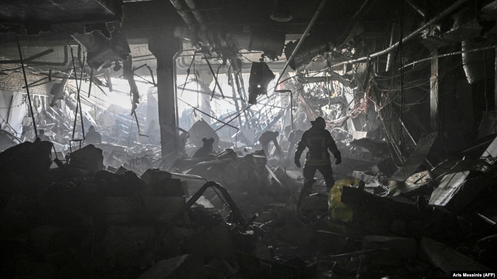 Ukraine -- A Ukranian serviceman walks between debris 