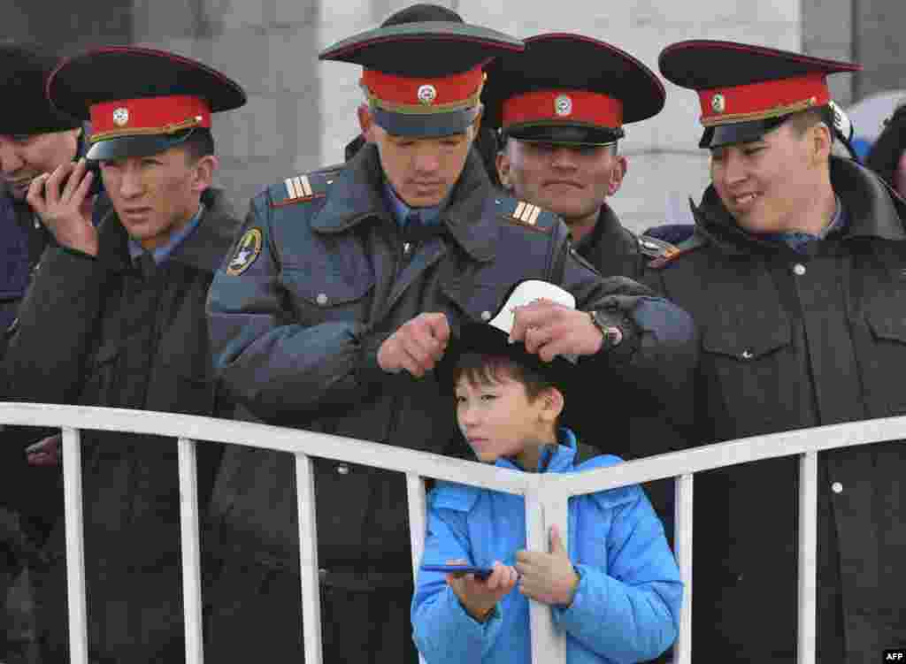 Police officers keep watch during Norouz celebrations in the central Ala-Too Square in Bishkek.