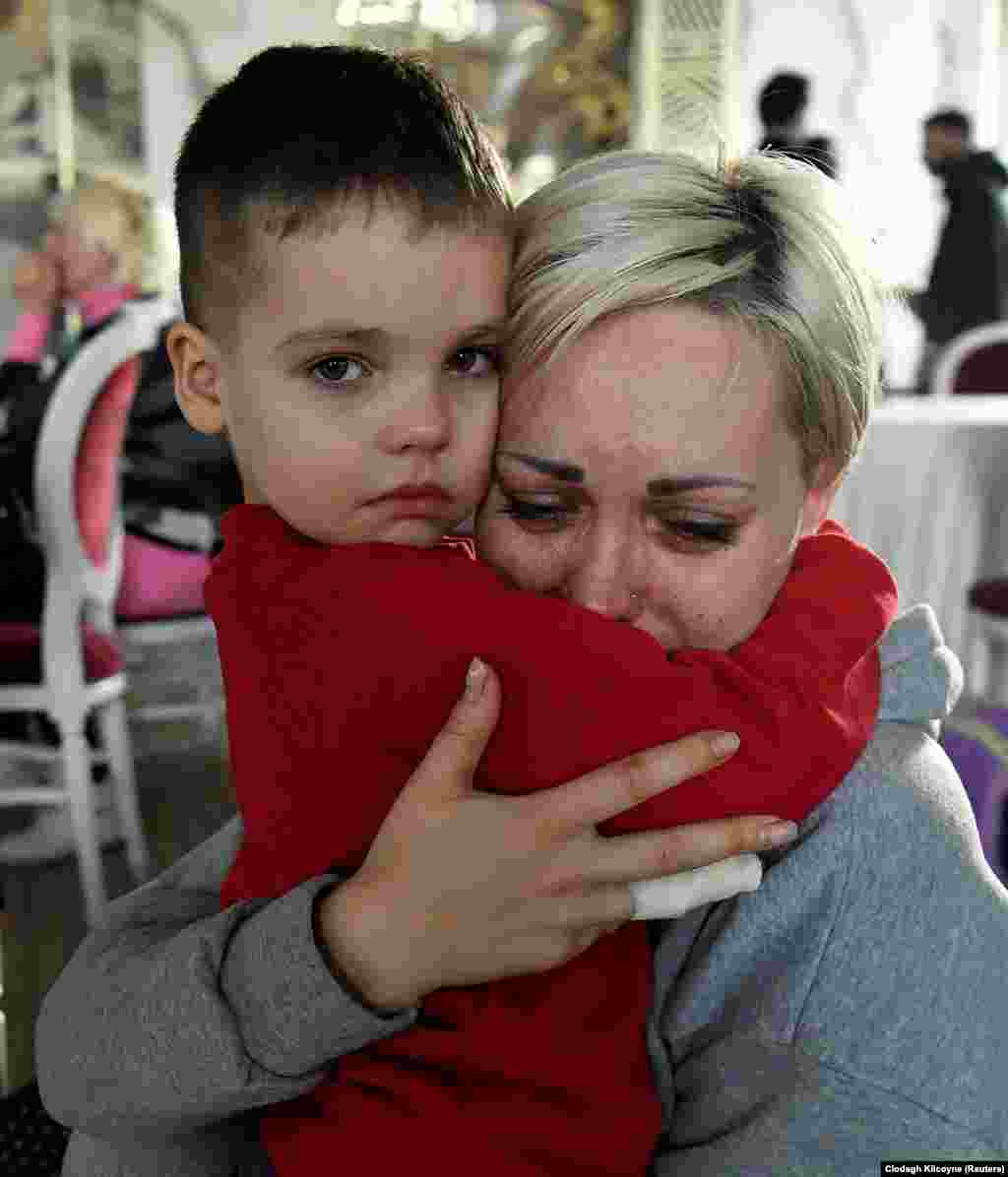 Helen Yakubets cries with her 5-year-old son inside a ballroom that has been converted to a temporary shelter in Suceava, Romania, on March 20. The woman&#39;s husband and teenage son remain behind in Ukraine.&nbsp;