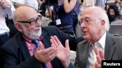 Belgian physicist Francois Englert (left) and British physicist Peter Higgs talk at a July 12 news conference on what is thought to have been confirmation of the existence of the Higgs boson at the European Organization for Nuclear Research (CERN) in Meyrin.