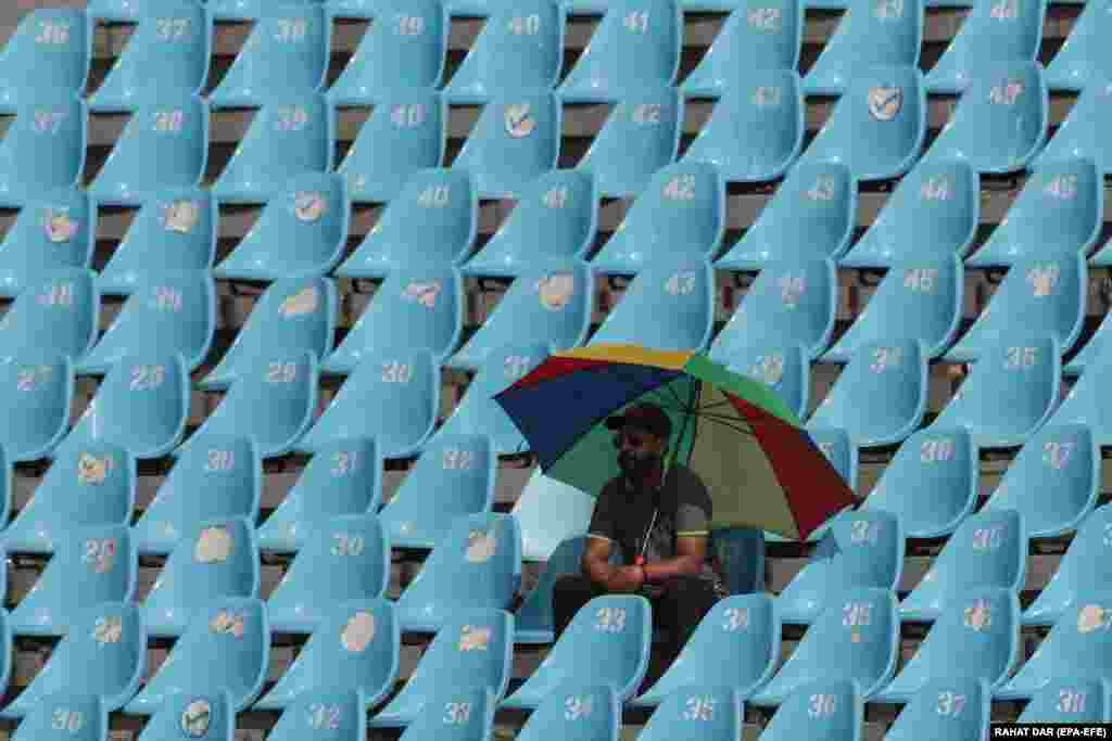 A spectator watches the second day of the third cricket test match between Pakistan and Australia at the Gaddafi Cricket Stadium in Lahore.
