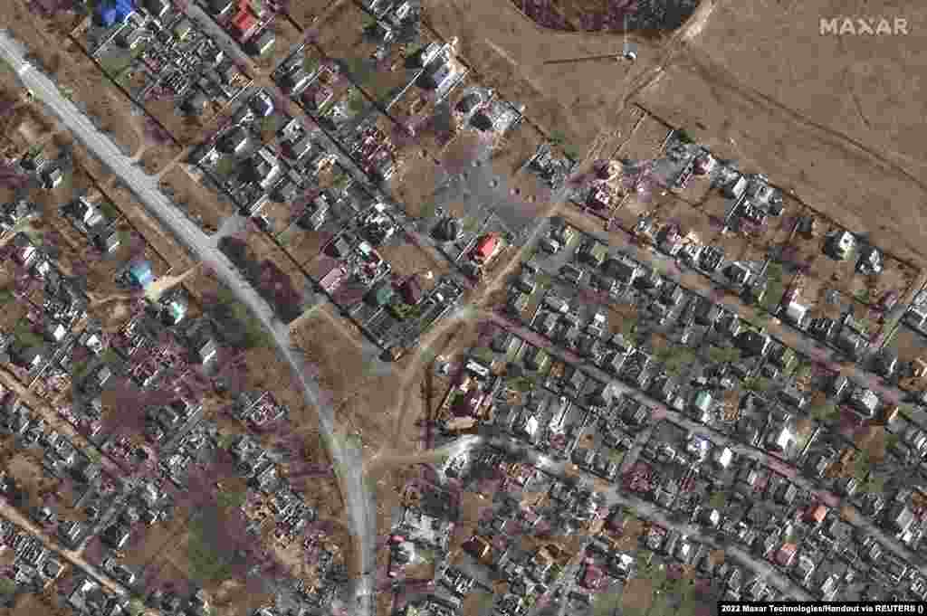 Craters from artillery shells can be seen amid destroyed homes in Novoselivka, northeast of the city of Chernihiv, on March 21.