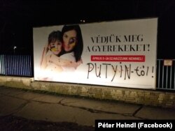 Heindl sprayed "from Putin" in black letters underneath the words "Protect our children!" on a billboard. Other times, his addendum might read "from Fidesz."