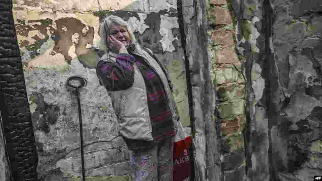 UKRAINE-A woman reacts as she stands inside a burnt house hit by Russian Grad rockets in Kyiv&#39;s Shevchenkivsky district, on March 22, 2022, as for the first time, there are signs that Ukrainian forces are going on the offensive, retaking a town near Kyiv 