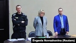 Aleksei Navalny (left) appears with his lawyers Olga Mikhailova (center) and Vadim Kobzev appear via a video link during a court hearing in March 2022.