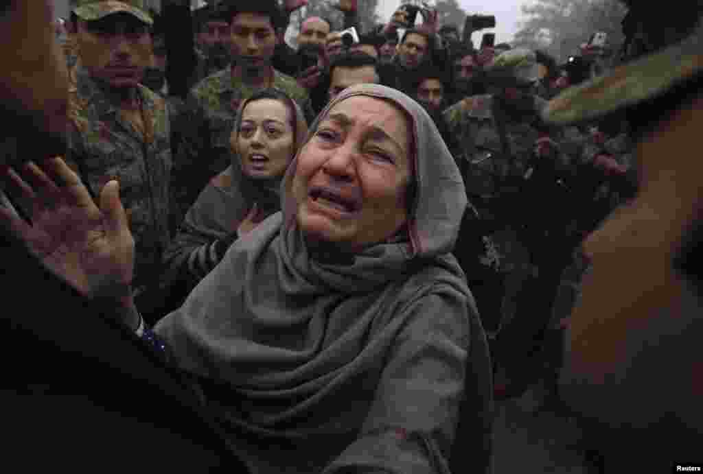 The grandmother (right) and mother of Muhammad Ali Khan, a student who was killed during an attack by Taliban gunmen on an army-run school in Peshawar, react during a visit by Imran Khan (left), chairman of the Pakistan Tehrik-e-Insaf (PTI) political party. (Reuters/Fayaz Aziz)