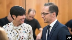 German Foreign Minister Heiko Maas, right, talks to Norwegian Foreign Minister Ine Eriken Soereide at the beginning of the conference on the lake chad region in Berlin Monday, Sept. 3, 2018. (Bernd von Jutrczenka/dpa via AP)