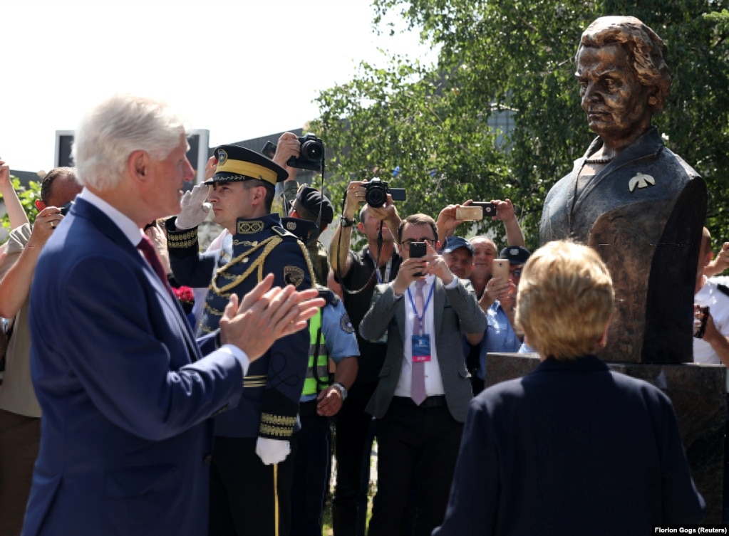 Ish-presidenti amerikan, Bill Clinton, duartroket, teksa Madeleine Albright shikon zbulimin e bustit dedikuar saj në Prishtinë, që u zbulua në 20-vjetorin e hyrjes së trupave të NATO-s në Kosovë. Prishtinë, 12 qershor 2019.