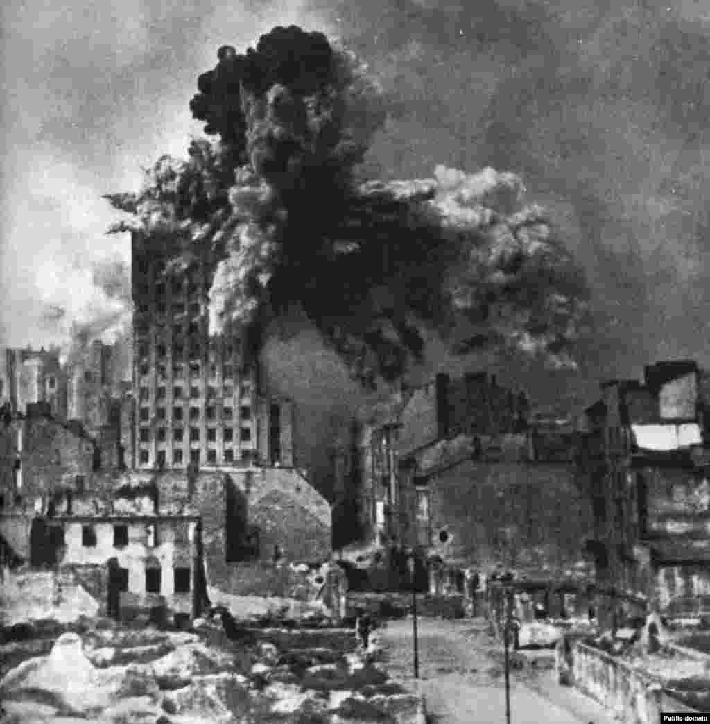 A building in Warsaw is hit with a giant German mortar shell in August 1944.