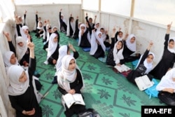 Afghan girls attend a class at their primary school in Kandahar on March 23.