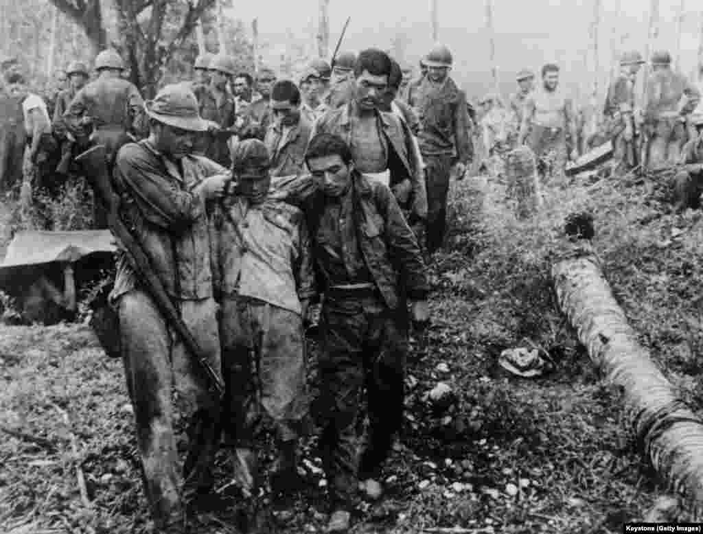 Japanese soldiers being helped by American troops after the capture of a Japanese stronghold on Guadalcanal in the Solomon Islands in an undated photo from World War II.&nbsp;