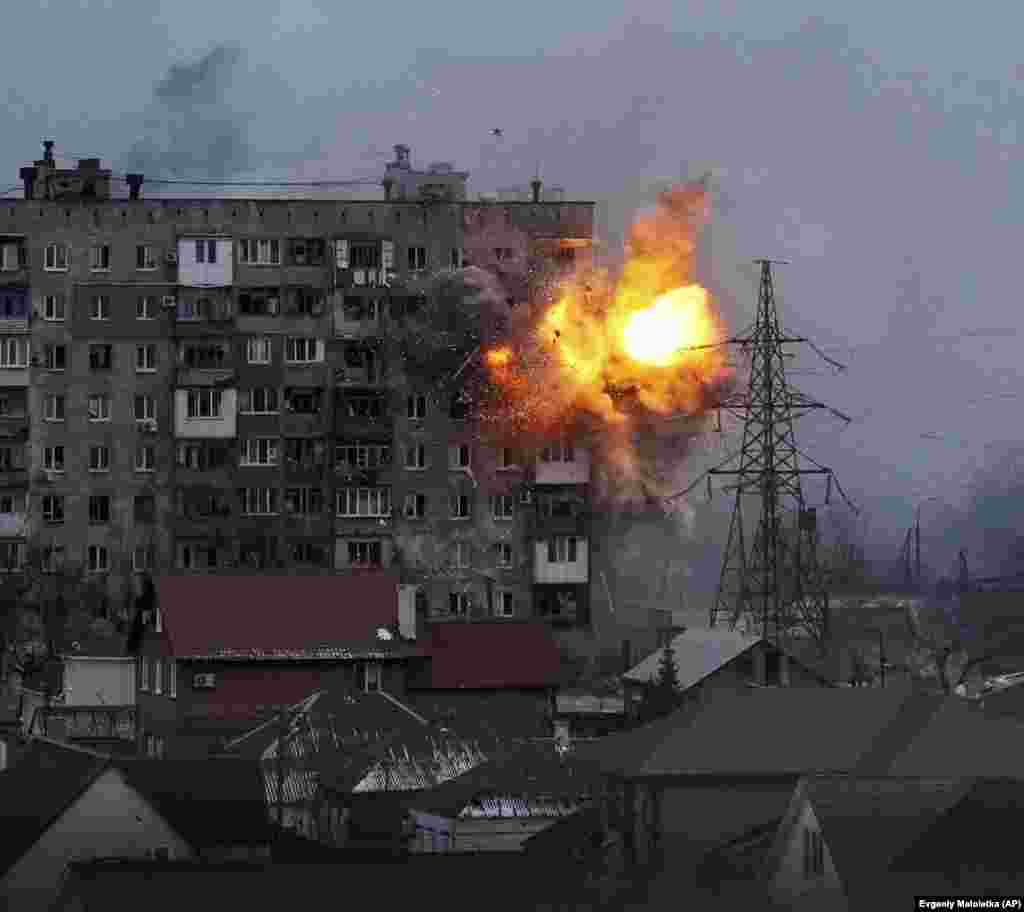 An apartment building explodes after being hit by a shell from a Russian tank in Mariupol on March 11.&nbsp;