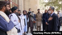 Taliban Deputy Prime Minister Mullah Abdul Ghani Baradar and other Taliban officials greet Chinese Foreign Minister Wang Yi in Kabul on March 24.