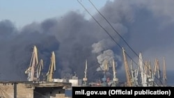 Дым от пожара на российском военном корабле, уничтоженном украинскими военными в Бердянске, Украина, 24 марта 2022 года