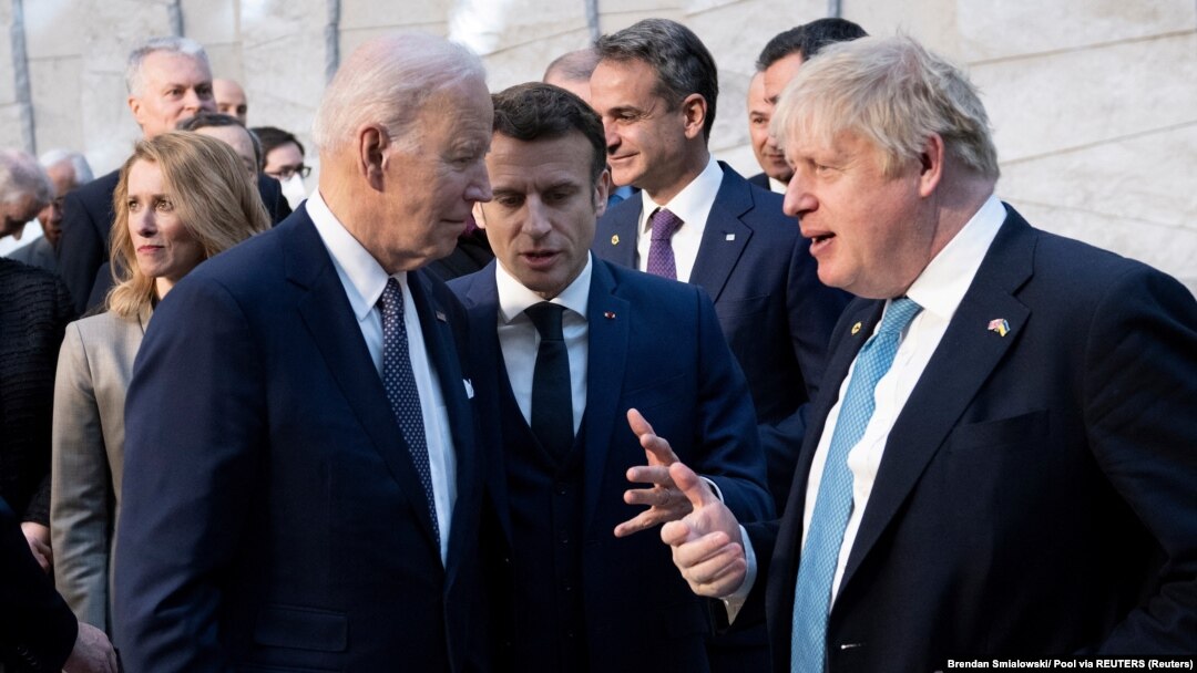 U.S. President Joe Biden (left) talks with French President Emmanuel Macron (center) and Britain's Prime Minister Boris Johnson ahead of an extraordinary NATO summit in Brussels on March 24.
