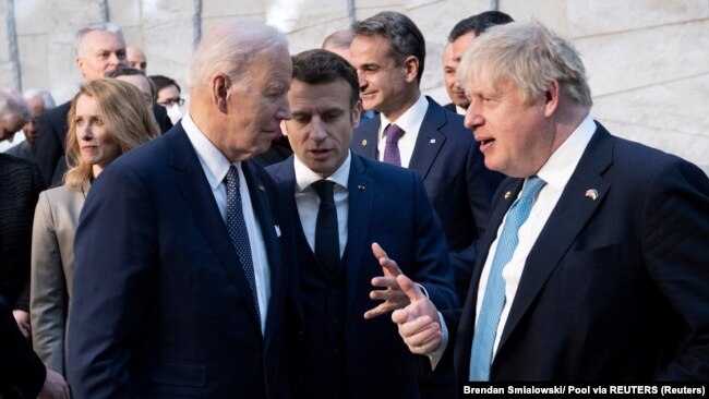 U.S. President Joe Biden (left) talks with France's President Emmanuel Macron (center) and Britain's Prime Minister Boris Johnson ahead of an extraordinary NATO summit in Brussels on March 24.