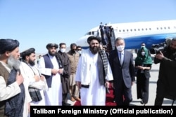 Taliban Foreign Minister Amir Khan Muttaqi welcomes Chinese Foreign Minister Wang Yi as he arrives in Kabul on March 24.