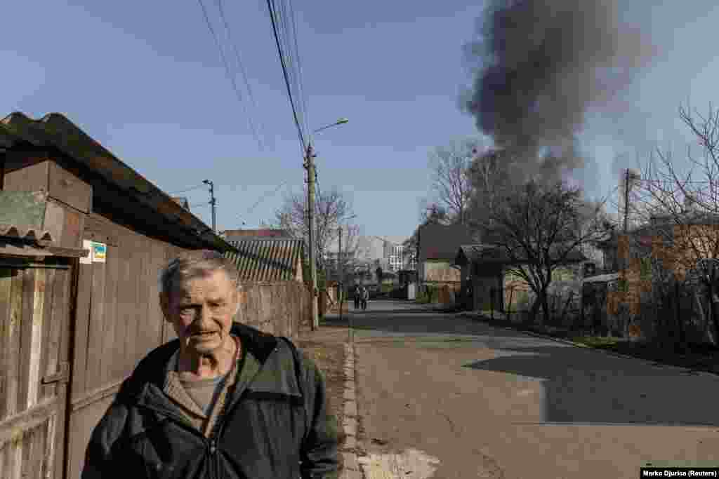 Smoke rises in an unidentified suburb of Kyiv after damage from shelling on March 23.&nbsp;