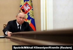 Vladimir Putin attends a meeting with government members via a video link in Moscow on March 10.