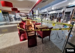 Restaurant furniture is taped off at Sheremetyevo airport near Moscow after a terminal was closed in connection with a huge drop in traffic since Russia invaded Ukraine.