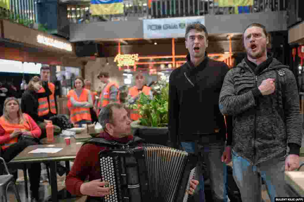 Volunteers sing the Ukrainian national anthem in an old theater in the southwestern port city of Odesa on March 13.