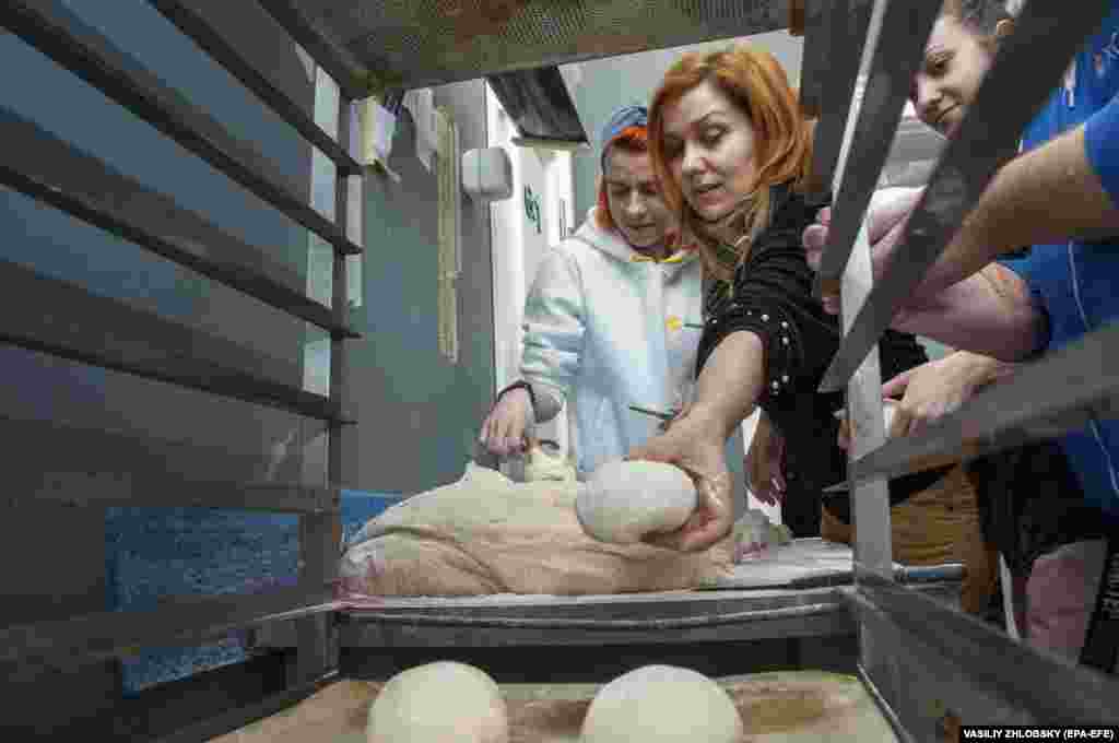 Volunteers bake bread for servicemen in the northeastern city of Kharkiv on March 22.