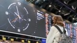 MOSCOW REGION, RUSSIA – MARCH 8, 2022: A girl looks at an information board in Terminal C of the Sheremetyevo International Airport. As of March 8, the Aeroflot Airline suspends all international flights, except flights to Minsk. Earlier, the Russian Fede