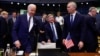 U.S. President Joe Biden (left) prepares to sit as he speaks with NATO Secretary-General Jens Stoltenberg at the alliance's headquarters in Brussels on March 24.