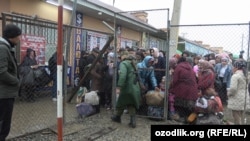 People wait to cross the Uzbek-Kyrgyz border on March 25. The border areas in Central Asia have been subject to recurring disputes since the collapse of the Soviet Union in 1991.