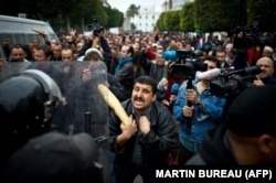 A Tunisian protester holds a baguette during a demonstration in Tunis in 2011.