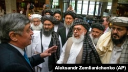 Russian special envoy to Afghanistan Zamir Kabulov (left) speaks with Mullah Abdul Ghani Baradar, the Taliban's top political leader (third left) and other members of the hard-line Islamist group in 2019.