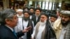 Russian presidential envoy to Afghanistan Zamir Kabulov (left) speaks to Mullah Abdul Ghani Baradar, the Taliban group's top political leader (third left) and other members of the Taliban in Moscow in 2019.