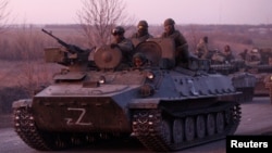 An armored convoy of pro-Russia troops travels on a road leading to the besieged Ukrainian port city of Mariupol on March 28. 