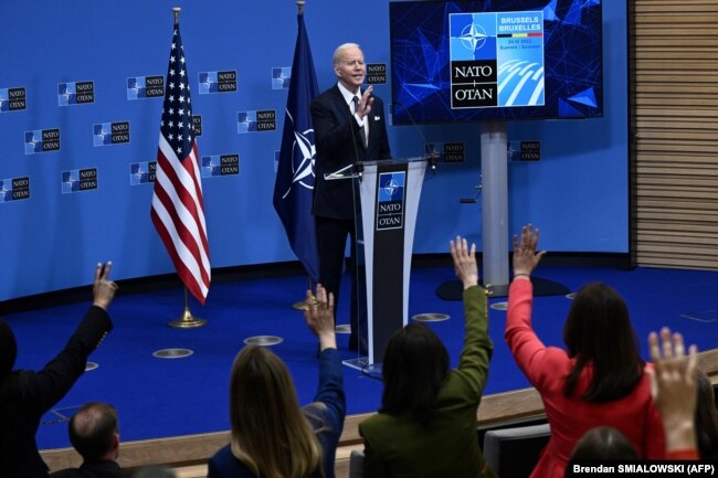 U.S. President Joe Biden gestures as media representatives raise their hands to question him during a press conference at NATO headquarters in Brussels on March 24.