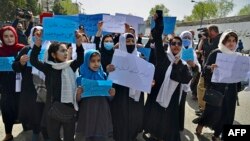 Afghan women and girls protest outside the Education Ministry in Kabul on March 26 to demand that high schools be reopened for girls.
